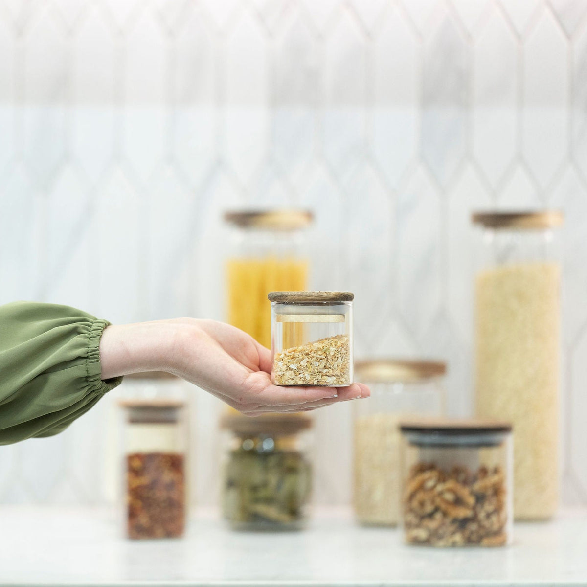 Square Acacia Spice Jars – 3 Sizes displayed on a kitchen countertop, ideal for adding elegance to pantry organisation.