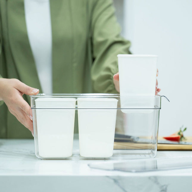 Person using Triple Clear Fridge Organiser with Removable Baskets for efficient kitchen organisation on a countertop.