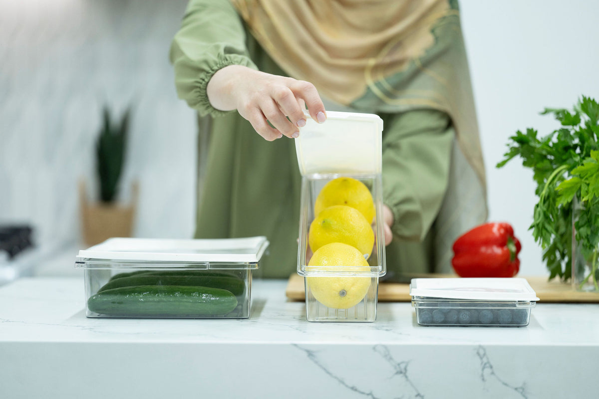 Person using 10-Piece Fridge & Freezer Storage Set – The Ultimate Organisation Solution to store lemons, demonstrating kitchen organisation.