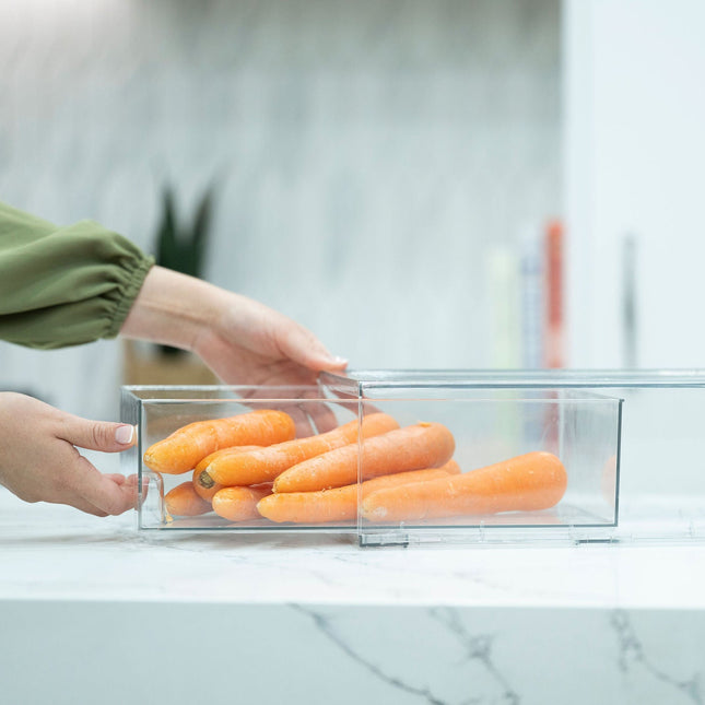 Person using Clear Modular Drawer Organiser - Medium to store carrots on a kitchen countertop for easy pantry organisation.