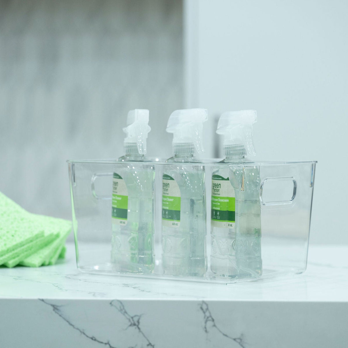 Clear Multi-Use Storage Tub With Lip – XL holding spray bottles on a kitchen counter, ideal for under sink storage and organisation.