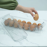 Egg organiser with lid for secure fridge storage, ideal for kitchen organisation. Holds dozen eggs with easy access.