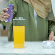 Clear Drink Container – 2 Liter being filled with orange juice on kitchen counter
