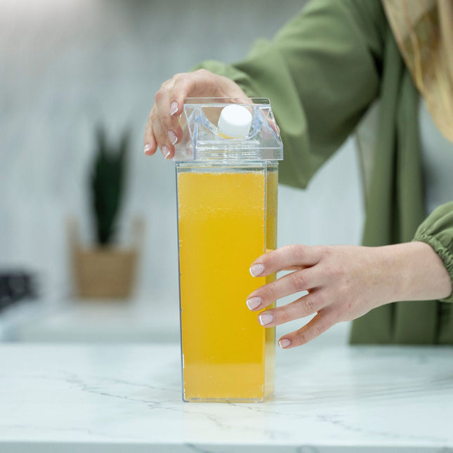 Person using Clear Drink Container – 2 Liter for kitchen organisers on marble bench
