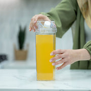 Person using Clear Drink Container – 2 Liter for kitchen organisers on marble bench