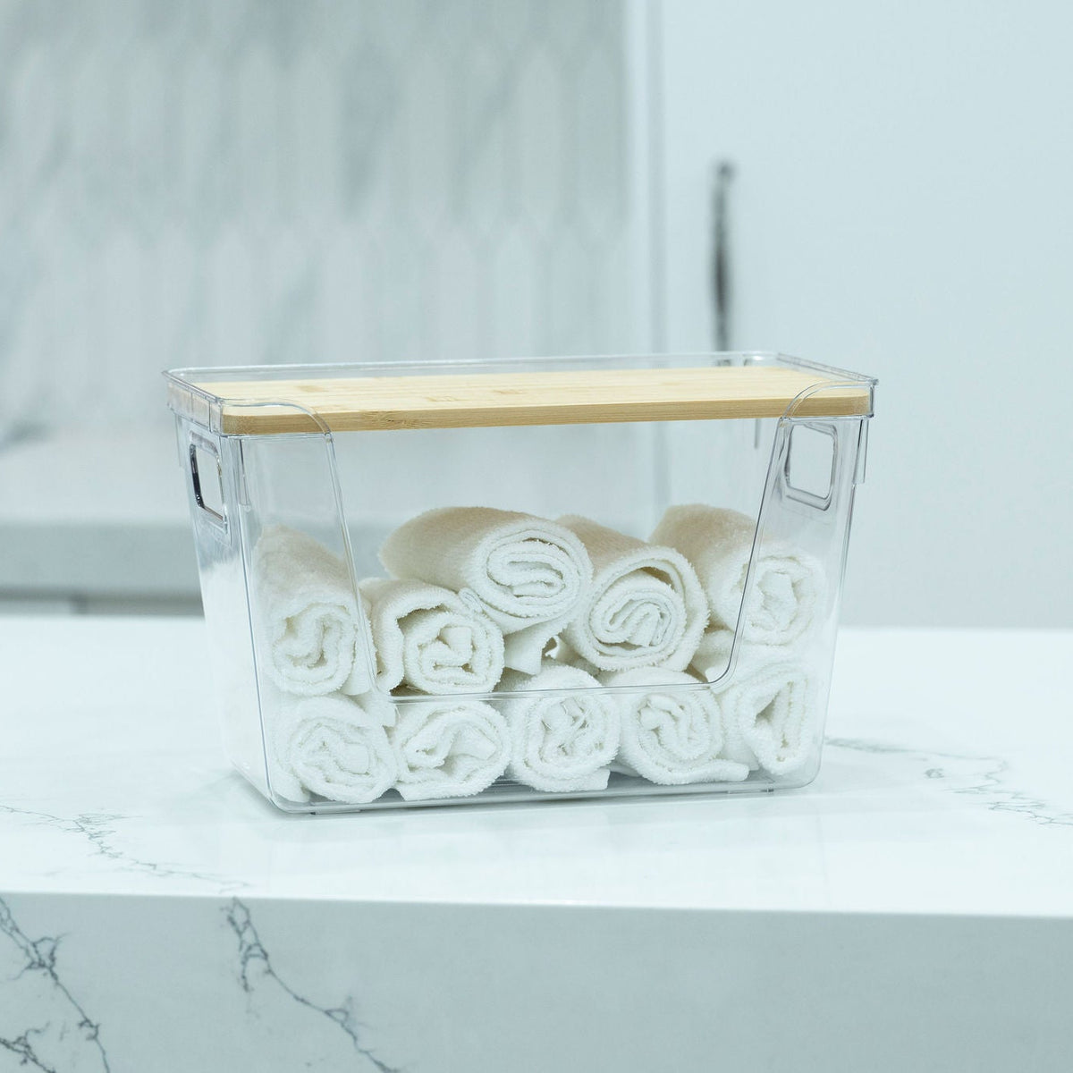 Clear Storage Container with Bamboo Lid – 29cm used for bathroom towel organisation, enhancing under sink storage efficiency.
