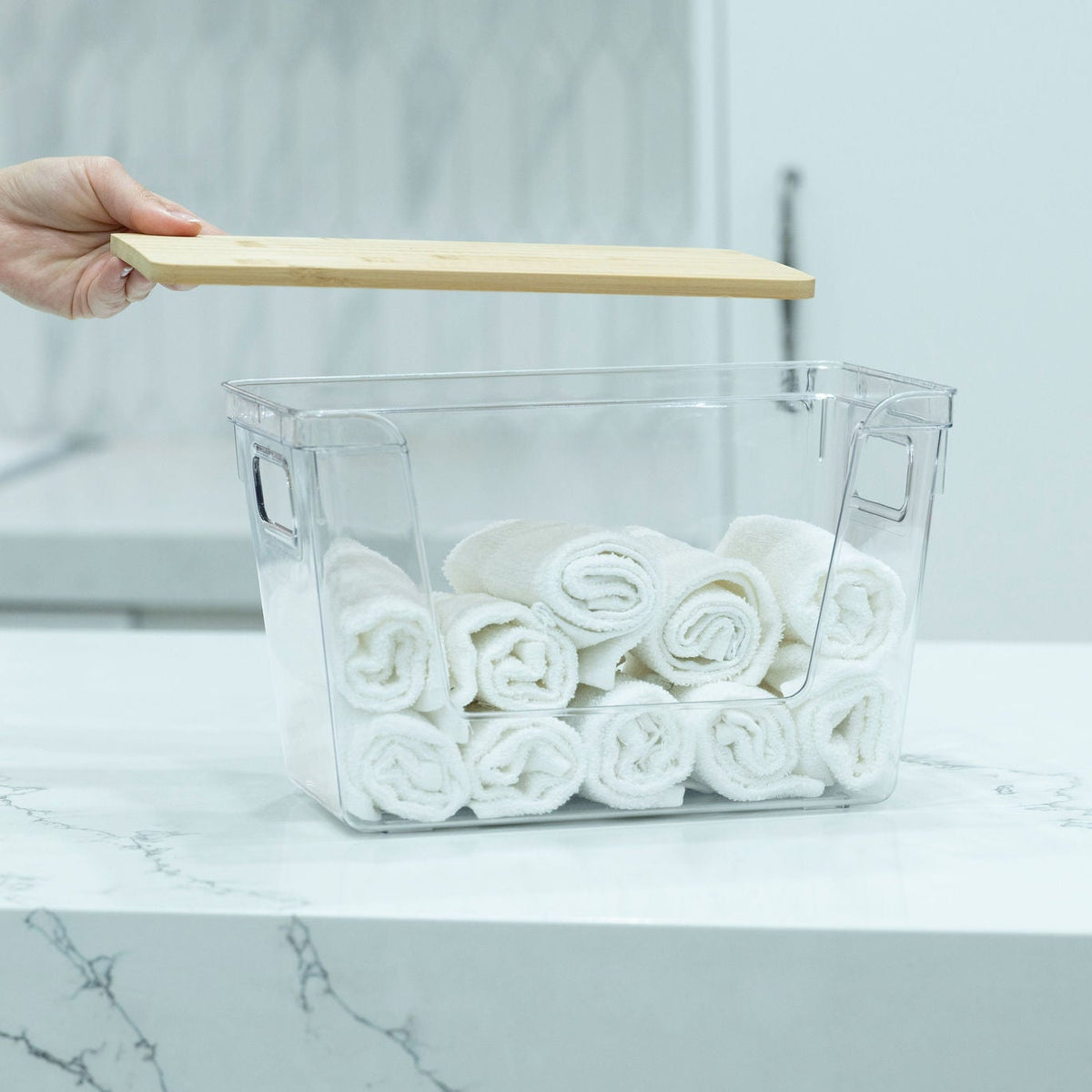 Clear Storage Container with Bamboo Lid – 29cm holding rolled-up towels, ideal for bathroom or pantry organisation.