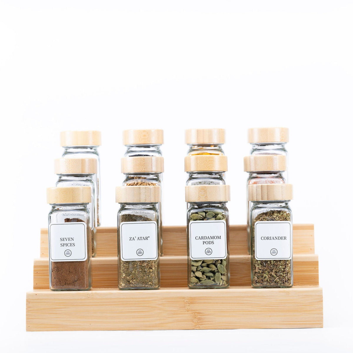 Glass jars filled with assorted spices on a bamboo rack, showcasing the Bamboo Shaker Spice Jar – 120 ml for kitchen organisation.