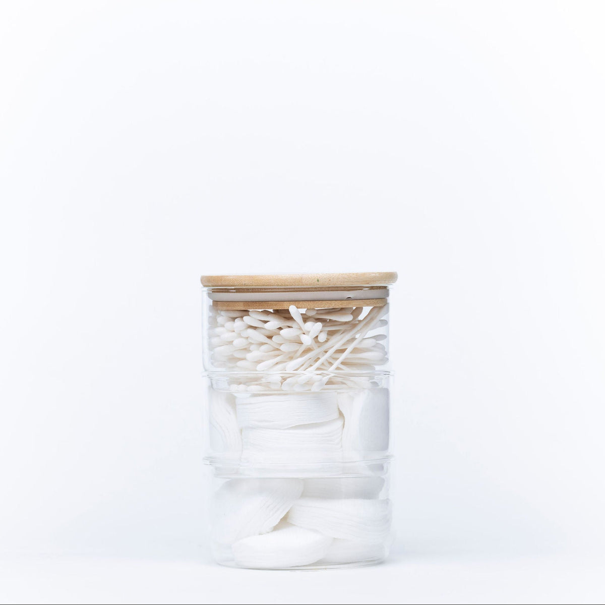 Stackable Round Bamboo Glass Jar – 450ml filled with cotton pads and swabs for bathroom storage and organisation.