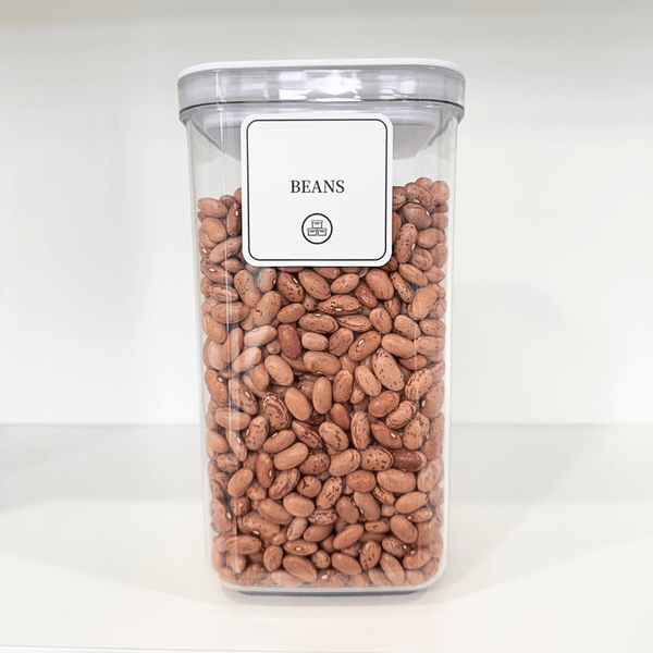 White airtight kitchen container with twist lock, filled with beans, ideal for pantry storage and home organisation.