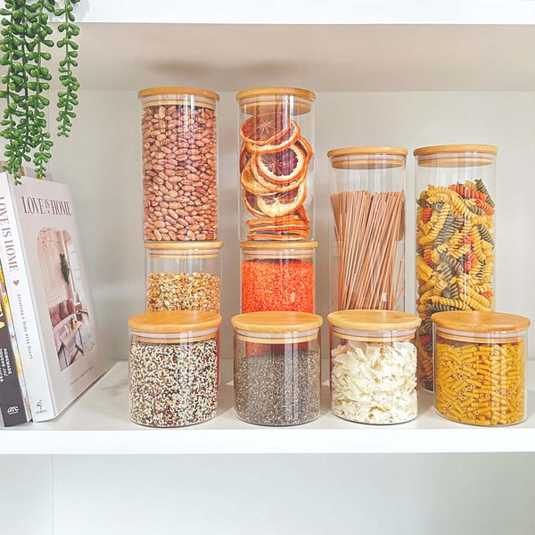 Round glass storage jars with bamboo lids, perfect for pantry organization and space-saving