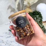Glass jar with bamboo lid containing chilli flakes, ideal for kitchen and pantry organisation; Bamboo Lid Spice Jar - 220ml Storage Organisers.