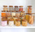 21 Acacia glass jars for pantry storage, filled with assorted kitchen essentials.