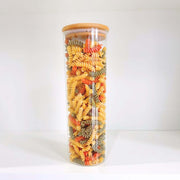 Tall round bamboo glass jar filled with colourful pasta, ideal for pantry organisation. Part of the Round Bamboo Glass Jars Small Pantry Set – 10 Pack.