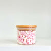 Round glass storage jar with bamboo lid filled with marshmallows, ideal for pantry organization.