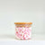 Round glass storage jar with bamboo lid filled with marshmallows, ideal for pantry organization.
